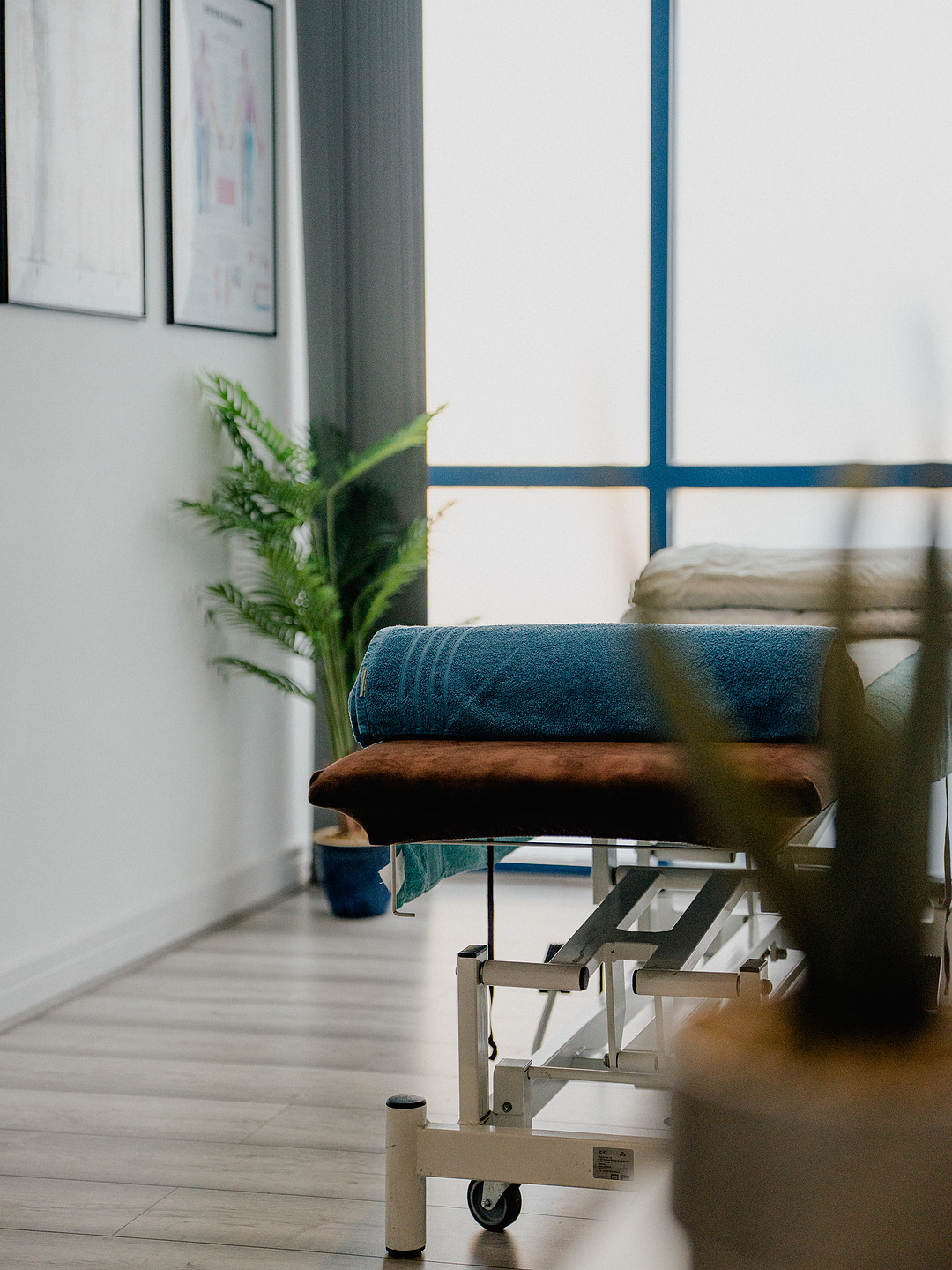 The treatment couch at Appleby Injury & Massage, made up beside the clinic window.